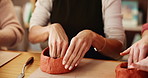 Friends, hands and women in pottery class for art, handmade craft and creative bowl. Clay, ceramic and group of people in workshop for hobby, design and diy mold in small business together closeup