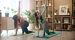 Women, yoga and crescent pose in home, together or stretching on floor for wellness in morning. Friends, people and fitness with pilates, lunge and start training for balance on exercise mat in house