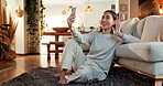 Woman, home and video call with conversation, phone and happiness in waving goodbye or blowing kiss. Female person, mobile tech and living room for online vlog, communication or social networking app