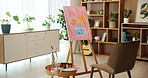 Canvas, art and empty studio in home with furniture, painting and creativity in morning with color. Room, house or apartment interior with easle, chair and workspace for drawing with flowers in vase