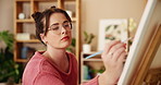 Brush, painting and artist with woman in studio for drawing, creative and inspiration. Calm, painter hobby and color with person and canvas in home workshop for design, fineart project and artwork