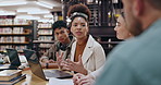 Students, laptop or talking in library for education, team project or feedback with research. Study group, people or tech in university for collaboration, information and workshop for productivity