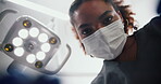 Woman, dentist and equipment in low angle for healthcare procedure in oral care clinic or hospital. Female person, orthodontist and examination as hygienist for teeth cleaning or root canal treatment