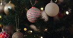 Hands, tree and decoration for Christmas, celebration and holiday aesthetic in house with ornaments. Woman, festive and vacation season in apartment for merry Xmas, party and event with sparkle ball