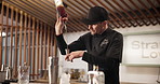 Man, alcohol shot and bartender at restaurant with cocktail for service, hospitality or catering. Event, waiter and male mixologist prepare drink for order at social lounge or pub for happy hour.