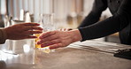 Hands, bartender and lemon in cocktail for serving customer, drink preparation and order closeup. Alcohol, glass service and barman giving person old fashioned whiskey with fruit slice on ice in pub