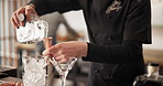 Man, alcohol shot and mixologist at restaurant with cocktail for service, hospitality or catering. Strainer, waiter and male bartender prepare drink for order at social lounge or pub for happy hour.