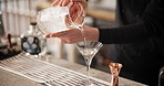 Hands, alcohol and bartender at restaurant with cocktail for service, hospitality or catering. Strainer, waiter and mixologist prepare drink for order at social lounge, club or pub for happy hour.