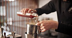 Hands, bartender and bottle in glass for mixology, alcohol and hospitality with catering in club. Barman, drinks and cocktail in hotel for happy hour, preparation and professional person with lemon