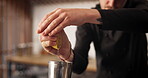 Hands, bartender and lemon in glass for mixology, alcohol and hospitality with catering in club. Barman, drinks and cocktail in hotel for happy hour, preparation and professional person with fruit