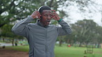 Running, fitness and black man with headphones in park for music, streaming playlist and radio. Sports, nature and person listening to audio for marathon training, exercise and workout for health