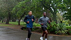 Men, running and people with exercise in nature for wellness, cardio and support in fitness training. Athlete, friends and runner with challenge at park for sports, workout and endurance in morning