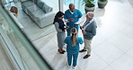 Man, doctors and discussion in lobby at clinic for paperwork, tablet and above for healthcare service. Hospital director, staff and team in scrum for meeting with diversity, feedback or collaboration