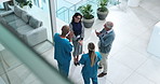 Woman, doctors and applause  for success in clinic lobby for support, goal or above for promotion. Hospital director, staff and group in scrum for achievement with cheers, celebration and diversity