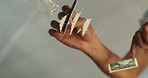 Person, hands and card with cocaine for lines, drugs or substance abuse on glass table below at home. Closeup, row or powder with dollar bill for crush, anesthetic or addiction and playing with dust