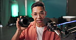 Live streaming, night and microphone with face of man for influencer, social media or content creator. Tech guru, promotion or product review with person in recording studio for feedback in broadcast