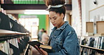 University, student and book with tablet in campus library for fact check study or online course. College, elearning and African woman with academy digital app for knowledge, info or project research