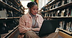 College, student and thinking with laptop in campus library for ebook study or online course. University, elearning and African woman with internet at academy for knowledge, info or project research