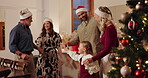 Family, holding hands and dance on Christmas at house for festive celebration, social reunion and movement. Smile, people and energy with hat, group performance and new years party for bonding trust