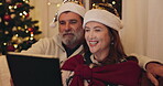 Christmas, mature couple and video call with tablet, social media and update in home. Internet, man and woman with living room for party, celebration and holiday with santa hat on lounge couch