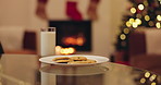 Christmas, home and milk with cookies, night and celebration with festive holiday. Empty, calcium and sweet snack with sugar treat, decorations for Xmas and food with glass and chocolate biscuit