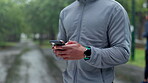 Exercise, man and hands with phone in park for training program, information and tracking progress. Male athlete, body and typing with technology in nature for fitness app, guide and workout tips