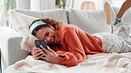 Funny, phone and relax with woman in living room of home for internet, meme or social media browsing. Dating app, laughing and smile with happy person in apartment for communication or text message