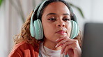 Thinking, woman and headphones for video, streaming or research with music, internet and idea. Person, apartment and girl with computer, website and online audio for podcast or online video search
