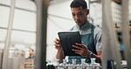Man, manager and tablet for checklist at distillery for alcohol manufacturing and production at warehouse. Male person, employee and counting for gin bottles at factory for delivery and supply