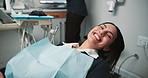 Woman, face and happy in dentist chair for check, inspection and mouth hygiene for healthcare at clinic. Doctor, person and equipment with oral wellness, cleaning and results at hospital in Portugal