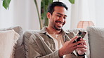 House, smile and man with smartphone, chatting and internet for social media, connection and texting. Happy person, apartment and guy on couch, cellphone and digital app for email, typing and message