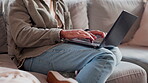 Home, man and hands with laptop on sofa for ecommerce website, research and reading reviews. Internet, network and male person with technology on couch for online shopping, information or application