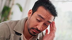 Asian man, headache and stress with vertigo on sofa for pain, dizziness or illness at home. Young, male person or inflammation with migraine or dizzy head for anxiety, fatigue or frustration at house