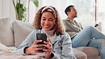 Happy woman, relax and chatting with phone on sofa for communication, texting or social media at home. Young, female person or interracial couple with mobile smartphone, app or watching tv at house