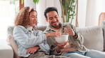 Interracial couple, relax and sofa with bowl of popcorn for snack, bonding or weekend together at home. Young, happy man or woman with meal or entertainment on lounge couch for watching tv at house