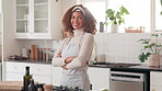 Face, arms crossed and woman in kitchen, smile and proud of small business, chef and girl in hospitality. Portrait, entrepreneur and person with apron, happy and professional in house and skills