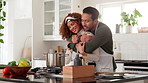 Happy, interracial couple or hug with pot for cooking, embrace or love together in kitchen at home. Young, man or woman with smile for support, care or lunch preparation for meal in teamwork at house