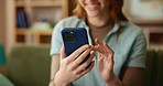 Woman, hands and phone with communication on sofa for dating app, platform and profile information. Female person, happy and scroll with technology at home for match, response and online conversation