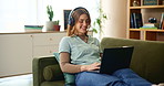 House, laptop and woman with headphones, music and internet with connection, sound and podcast. Person, apartment and girl in lounge, pc and headset for live streaming, happiness and comfort on sofa