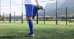 Legs, stretching and warm up as soccer player or athlete for sports, practice and training in field. Person, feet and preparation for challenge, match or football game in workout, fitness or exercise