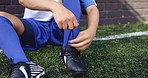 Football player, hands and shoes for game on field with getting ready, competition match and fitness practice. Sport, athlete and person tie shoelace on grass pitch for soccer tournament and training