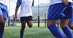 Football, team and legs with warm up for fitness on field with jumping, exercise and workout for competition. Sport, endurance and training on grass pitch for soccer match, performance and tournament