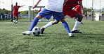 Football, man and game on field for action, technique or competitive tournament. People, soccer players or sport at community outreach program for practice, training or challenge on grass at facility