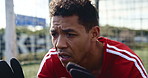 Goalkeeper, active and man with gloves, soccer and determination for competition, field and fitness. Football, training and energy for event, workout and person in stadium, game and professional