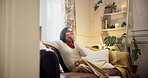 Tired woman, yawn and relax with sofa for fatigue, lazy or overworked in living room at home. Young, exhausted or female person in burnout on lounge couch for break or rest from long day at house