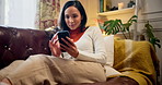 Happy, phone and woman relax on sofa for online chatting, social media and contact on weekend. Chill, home and person resting on smartphone for internet, website and communication in living room