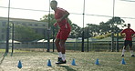 Man, fitness and cone with soccer outdoor of practice warm up, running progress and exercise performance. Athlete, beacon and speed challenge for football, sports formation and game training on field