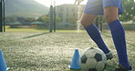 Feet, person and ball with cone for soccer of fitness practice, running guide and exercise performance. Athlete, beacon and warm up challenge with sports football, agile and game training on field