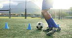 Feet, person and ball with cone for soccer of fitness practice, running guide and exercise performance. Athlete, beacon and warm up with football challenge, sports progress and game training on field