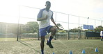 Black man, jump and cone for soccer with fitness practice, warm up guide and exercise performance. Male athlete, beacon and routine with football challenge, sport progress and game training on field